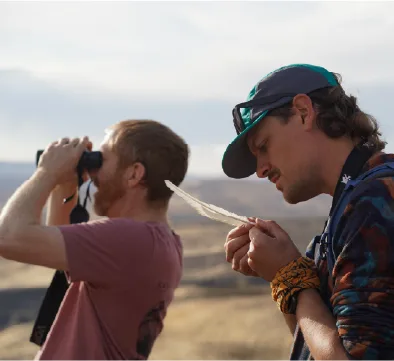 Two students looking through binoculars